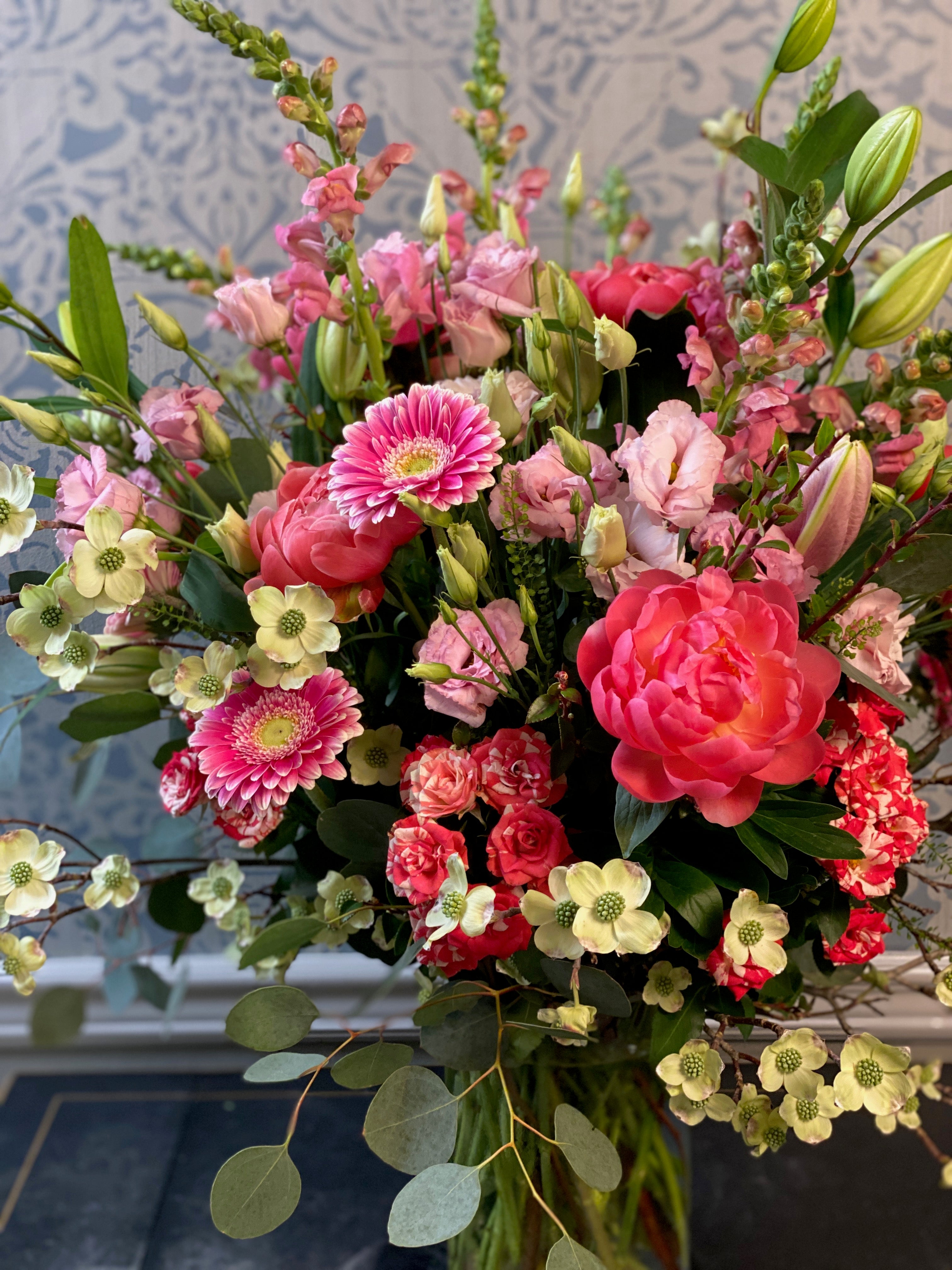 Bouquet of colorful flowers in a vase with a decorative background