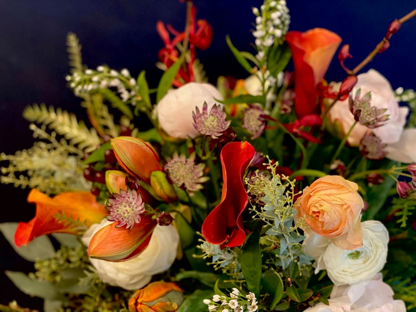 Beautiful vibrant bouquet on a blurred blue background.